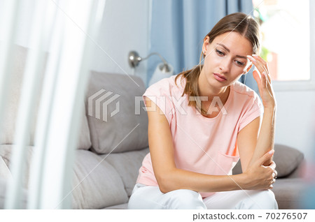 Sick female holding hands on her head 70276507