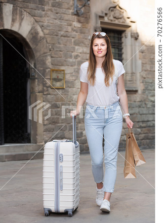Cheerful young female tourist walking in the city Cheerful young female tourist walking in the city 70276566