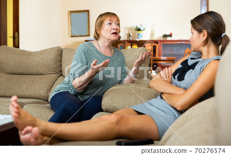 Daughter and aged mother quarrelling 70276574