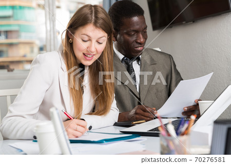 Friendly coworkers working together 70276581