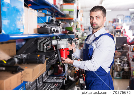 Man choosing drilling machine 70276675