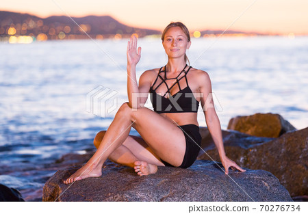 Adult woman is practicing stretching Adult woman is practicing stretching 70276734
