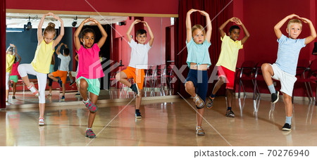 Glad little boys and girls hands up in class Glad little boys and girls hands up in class 70276940