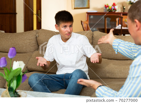 Grumpy father quarrelling with his son Grumpy father quarrelling with his son 70277000