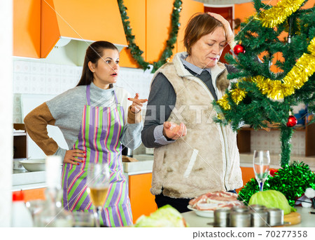 Woman having conflict with daughter during cooking xmas dinner Woman having conflict with daughter during cooking xmas dinner 70277358