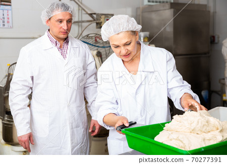 Bakers weigh the dough on the scales 70277391