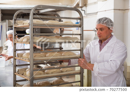 Baker carrying trolley with formed dough 70277500