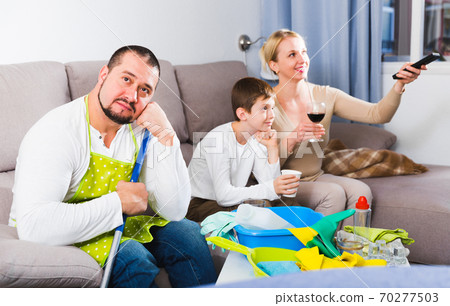Tired man dressed for cleaning Tired man dressed for cleaning 70277503