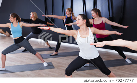Females exercising during yoga class Females exercising during yoga class 70277777