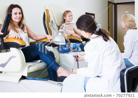 Women doing pedicure Women doing pedicure 70277921