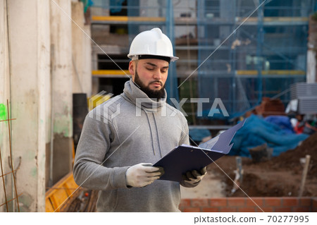 Engineer planning renovation works at building site 70277995