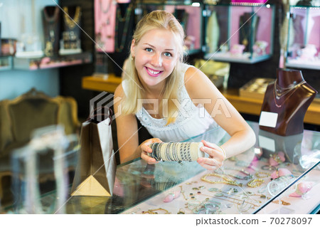 Woman buying bracelet in store Woman buying bracelet in store 70278097