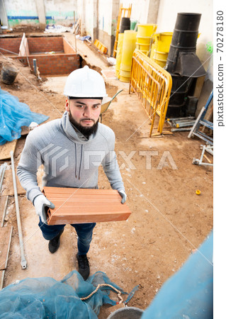 Bricklayer installing brick wall Bricklayer installing brick wall 70278180