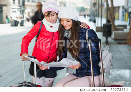 adult female and daughter with map adult female and daughter with map 70278214