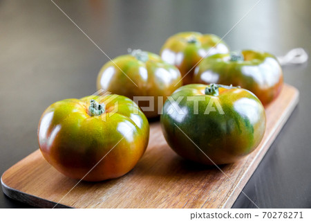 Black Krim organic tomatoes on a cutting board 70278271