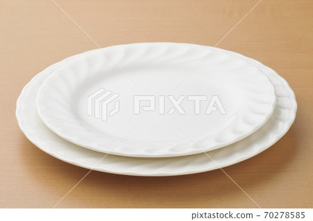 Plates, knives and forks placed on the table Plates, knives and forks placed on the table 70278585