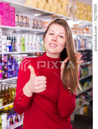 Satisfied female in cosmetics store Satisfied female in cosmetics store 70279009