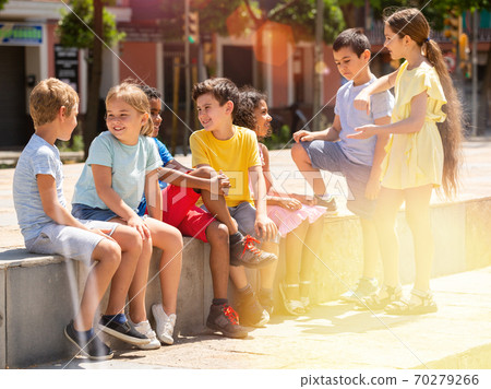 Group children are talking about play on walk in the park Group children are talking about play on walk in the park 70279266