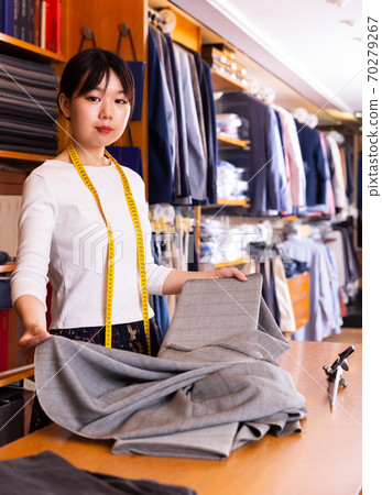 Nice Chinese salesgirl working in fabric store Nice Chinese salesgirl working in fabric store 70279267