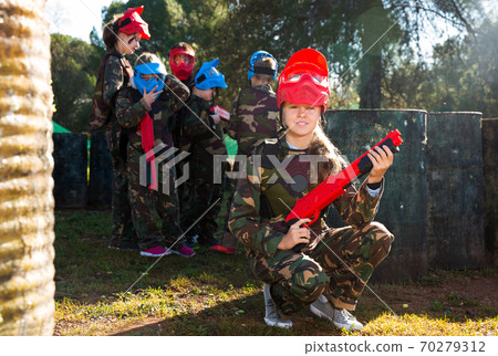 girl paintball player in camouflage standing 70279312