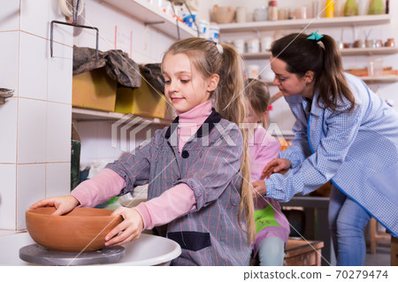 schoolgirls work on the potter's wheel schoolgirls work on the potter's wheel 70279474