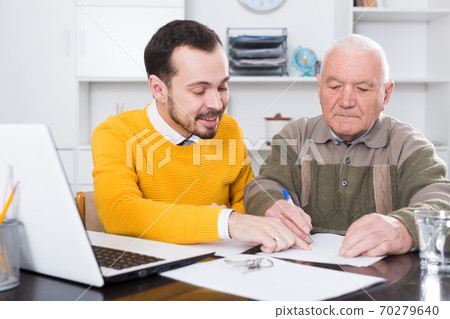 Old man and agent sign lease contract Old man and agent sign lease contract 70279640
