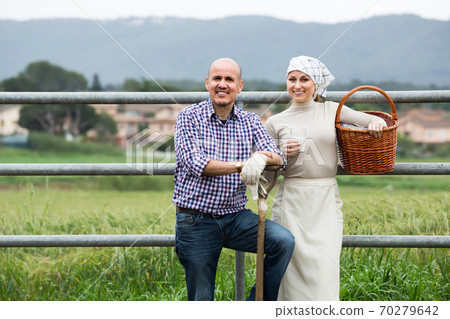 Two friendly farm workers taking a pause Two friendly farm workers taking a pause 70279642