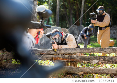 Paintball players aiming outdoors 70279643