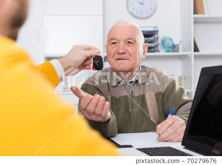 Man buying car in office Man buying car in office 70279676