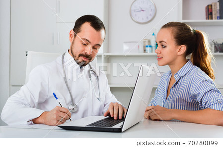 Woman having consultation with male doctor in hospital Woman having consultation with male doctor in hospital 70280099