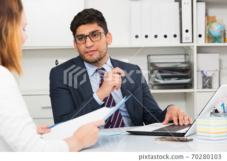 Businessman with female client Businessman with female client 70280103