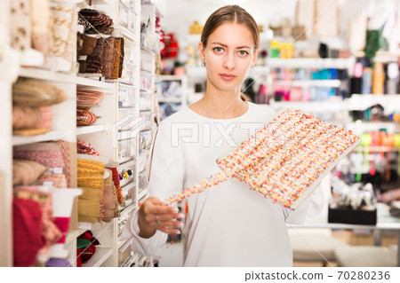 Salesgirl demonstrating ribbons Salesgirl demonstrating ribbons 70280236