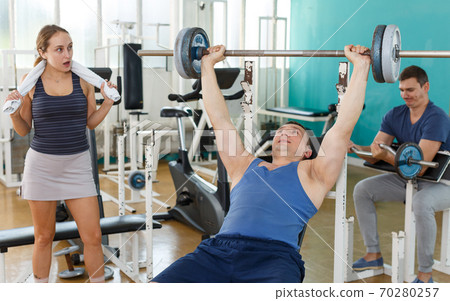 Sporty man practicing bench press Sporty man practicing bench press 70280257