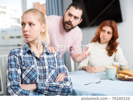 Young spouses and mother-in-low arguing indoors Young spouses and mother-in-low arguing indoors 70280320