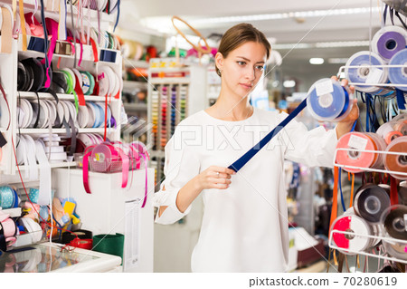 Woman choosing colorful ribbons Woman choosing colorful ribbons 70280619