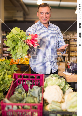 Man buying radish for salad 70280636