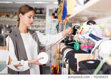 Woman choosing colorful ribbons 70280835