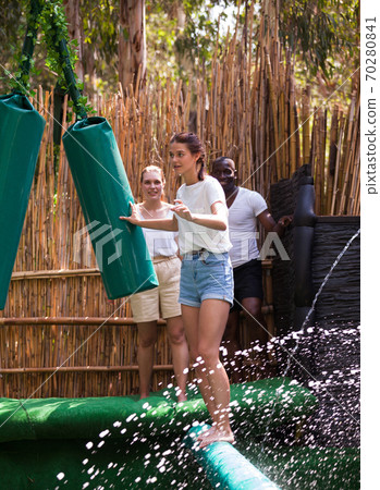 People passing horizontal bar at adventure park People passing horizontal bar at adventure park 70280841