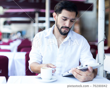 Man spending time in cafe outdoors Man spending time in cafe outdoors 70280842