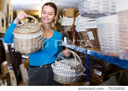 customer standing with wicker basket customer standing with wicker basket 70280880