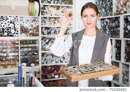 Salesgirl offering buttons Salesgirl offering buttons 70280881
