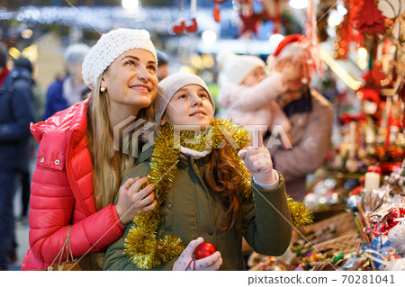 Happy mother and daughter at Christmas fair 70281041
