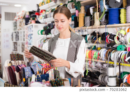 Seamstress looking for ribbons in haberdasher shop Seamstress looking for ribbons in haberdasher shop 70281062