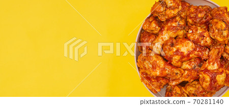 Buffalo chicken wings in a bowl on a yellow background, copy space Buffalo chicken wings in a bowl on a yellow background, copy space 70281140