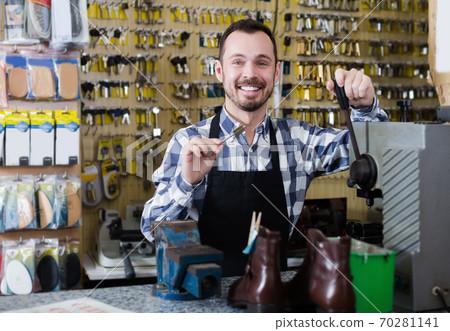 Smiling man worker displaying result of his key Smiling man worker displaying result of his key 70281141