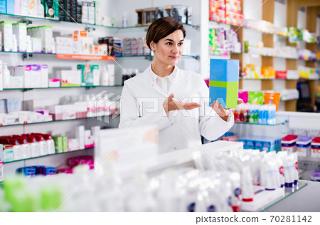 Female pharmacist suggesting useful body care products Female pharmacist suggesting useful body care products 70281142