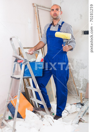 Engineer is standing with roller in uniform Engineer is standing with roller in uniform 70281259