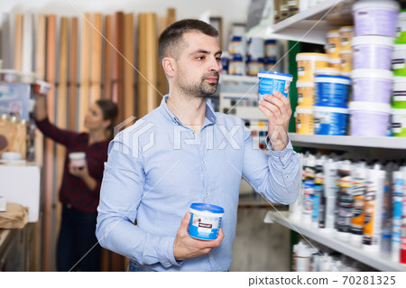 Cheerful male designer is holding paint Cheerful male designer is holding paint 70281325