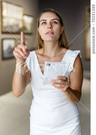 Woman visiting painting exhibition Woman visiting painting exhibition 70281388