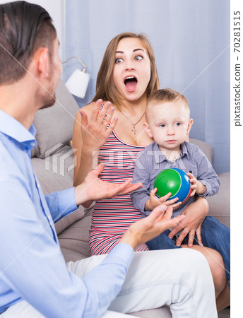 Smiling mother and father with little son talking Smiling mother and father with little son talking 70281515